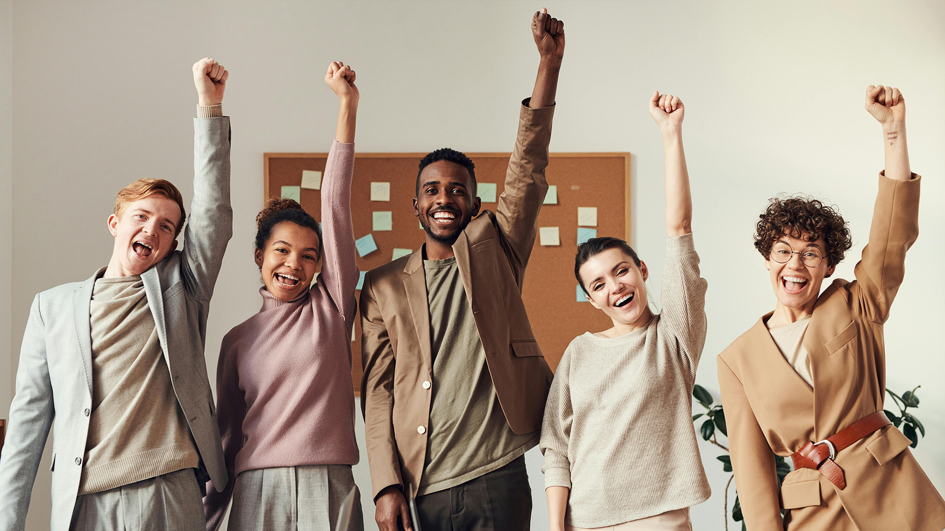 work team smiling with their fists in the air