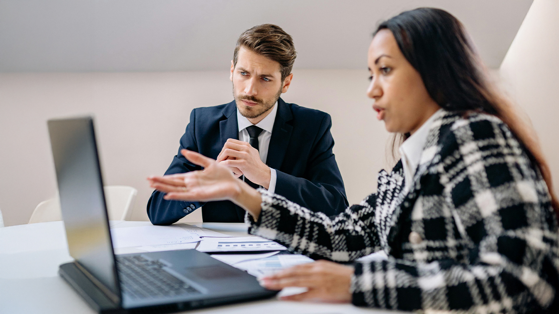 business leaders looking at a laptop in an office