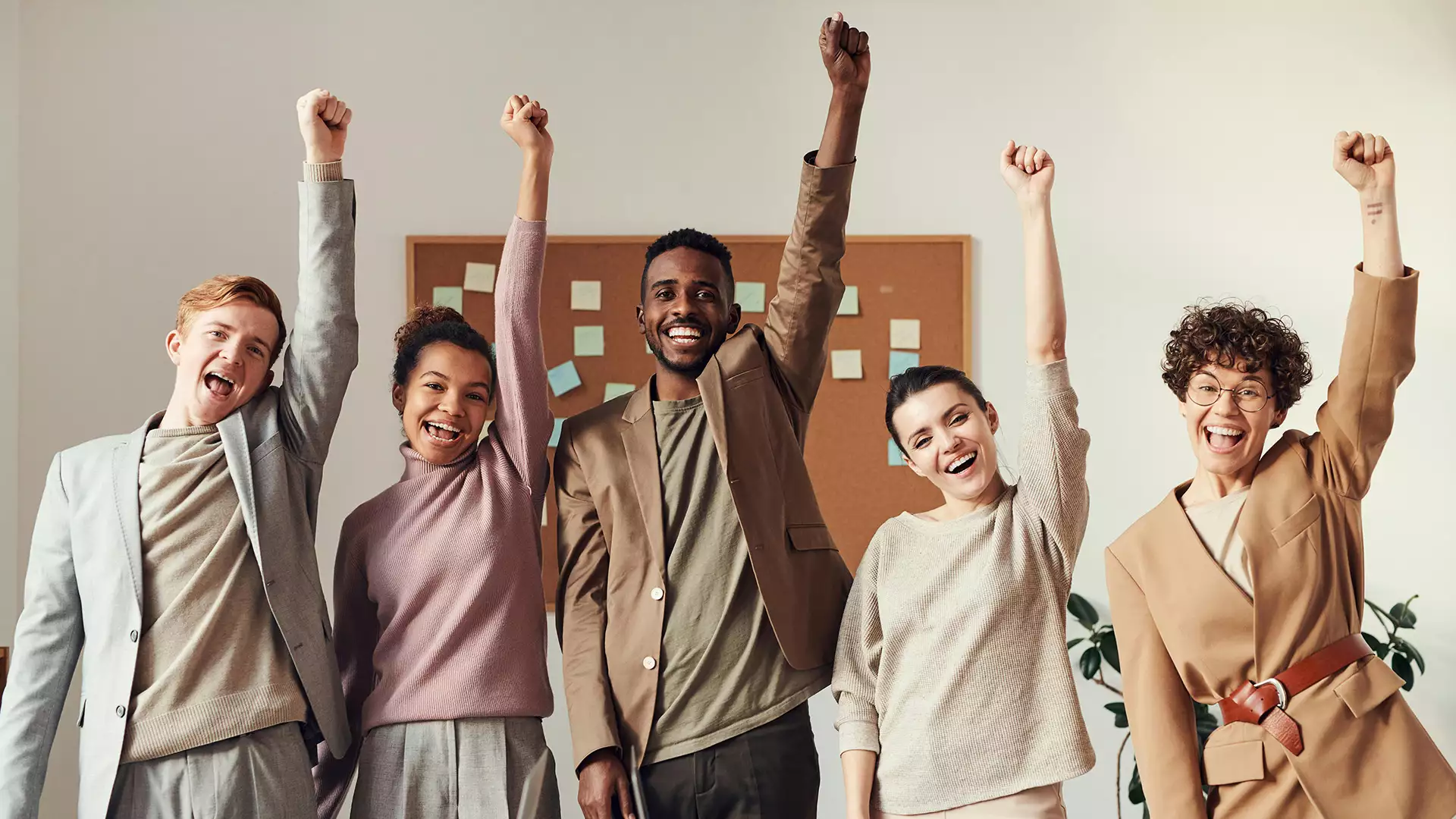 work team smiling with their fists in the air